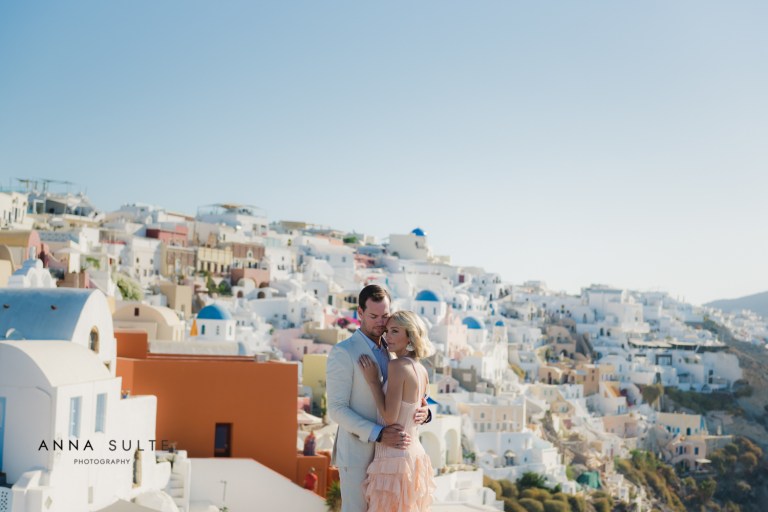 Couple next to Santorini blue domes