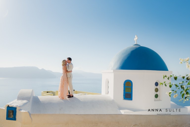 Couple on the rooftop in Santorini, blue church