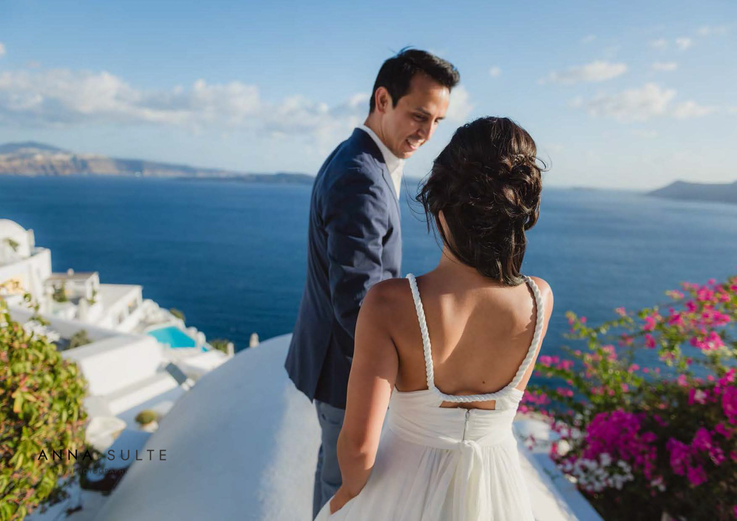 A couple walking on a rooftop in Greece