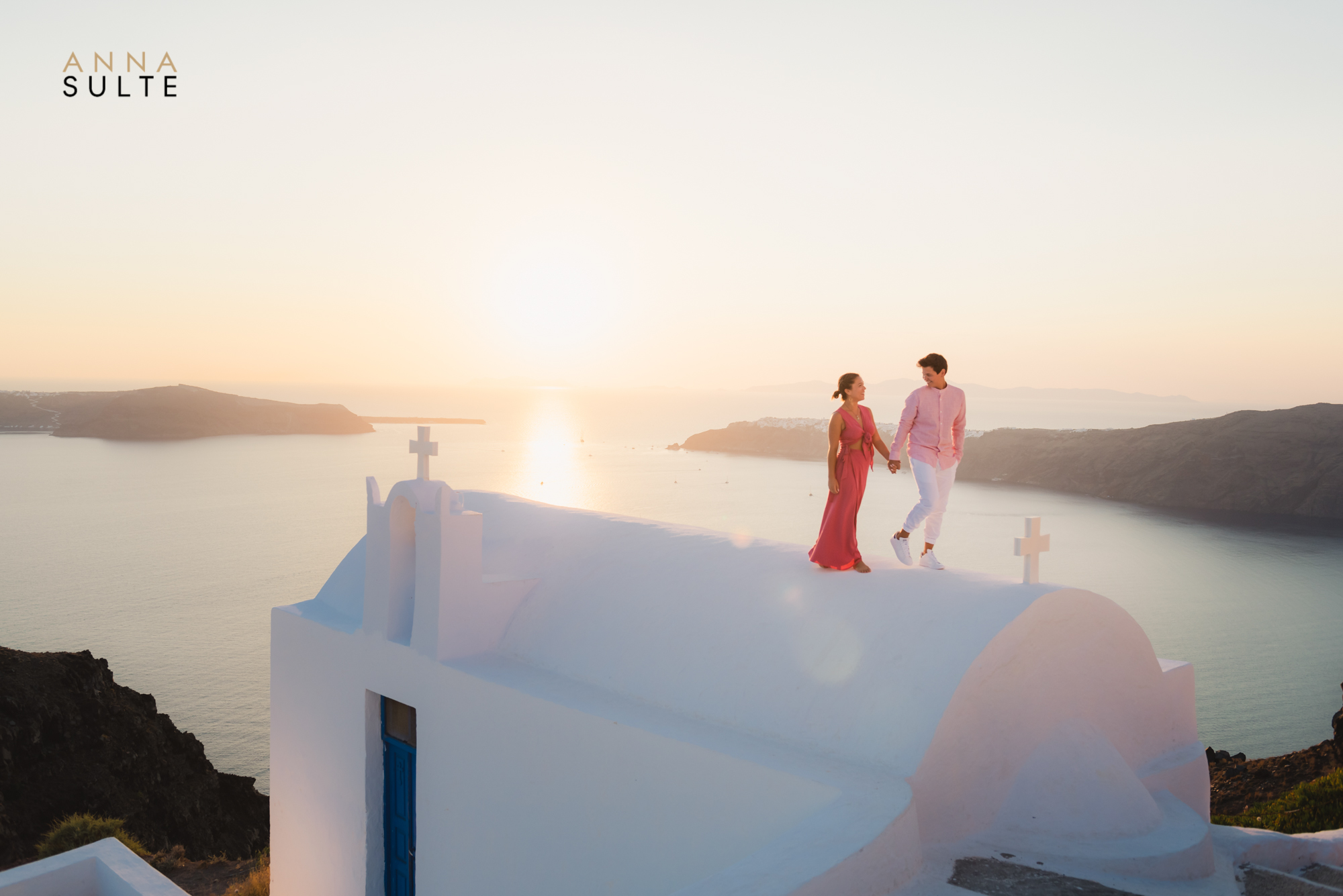 Photo of a couple on the rooftop in Santorini. Sunset shoot.