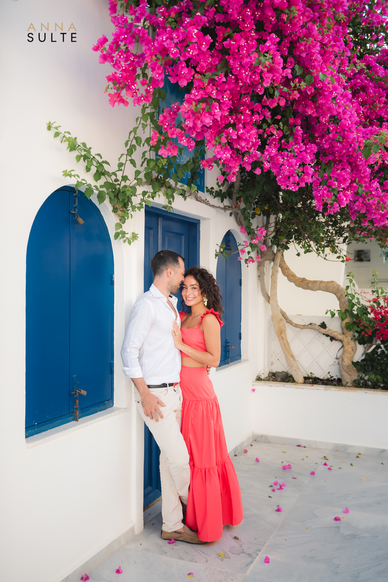 Santorini honeymoon photoshoot in Oia. Blue doors, bougainvillea flowers.