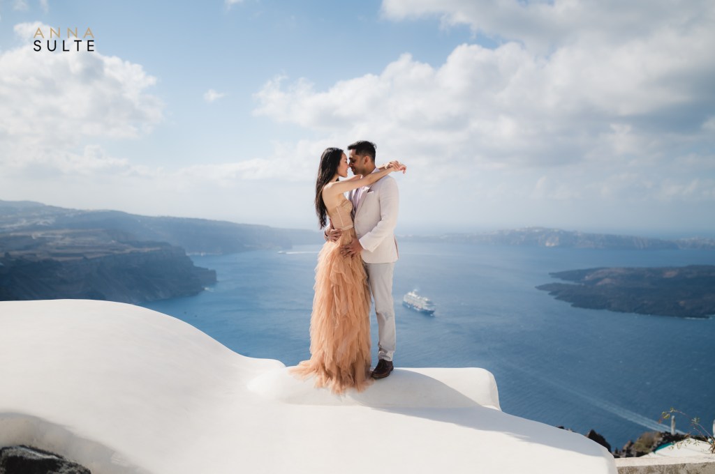 Wide photo angle of Santorini with a couple hugging