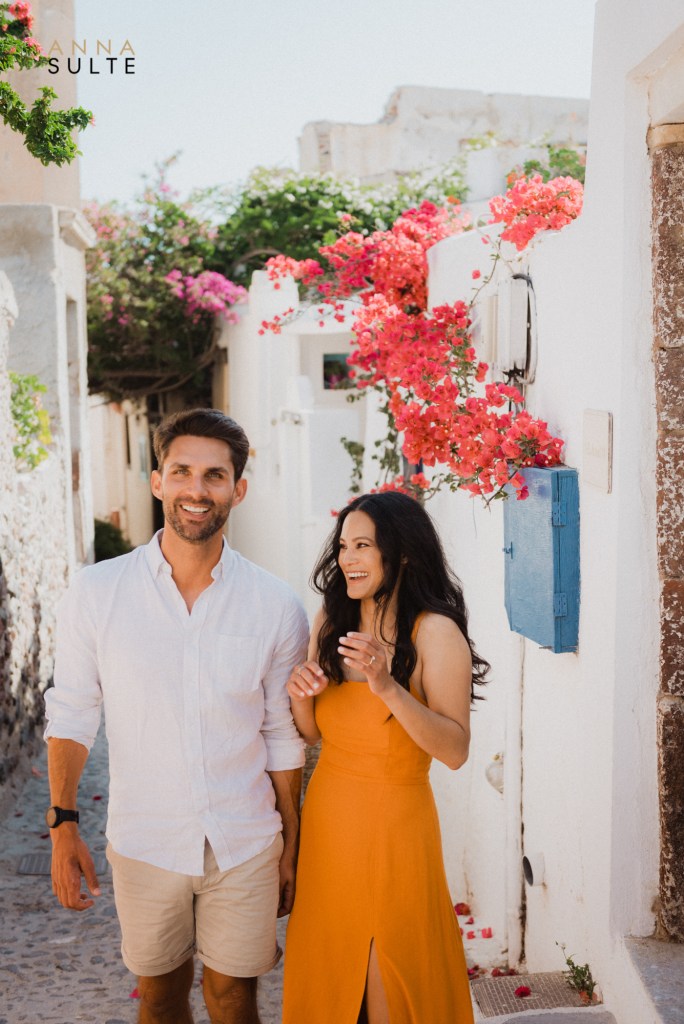 Couple laughing in Santorini. Summer vibes in Oia village.
