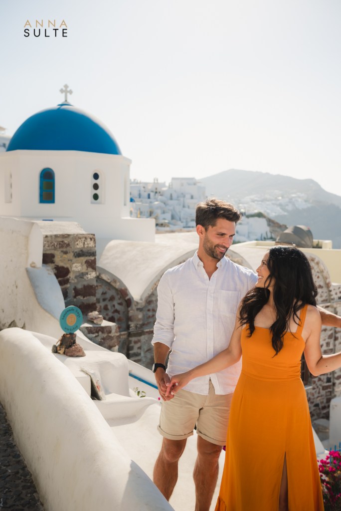 Newley engaged couple in Oia with blue roofs. Summer shoot.