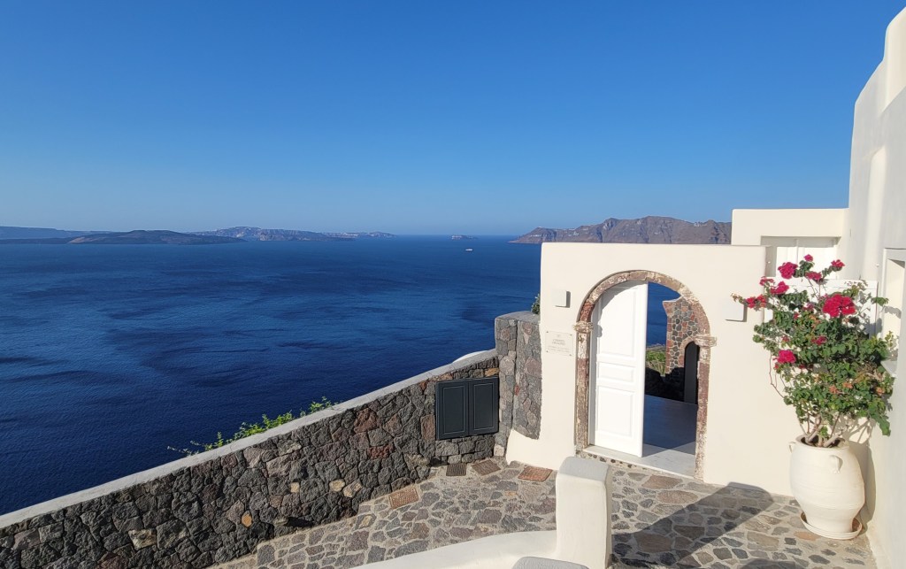 Stunning view from Canaves Oia Suites in Santorini, showcasing the breathtaking caldera and Aegean Sea.