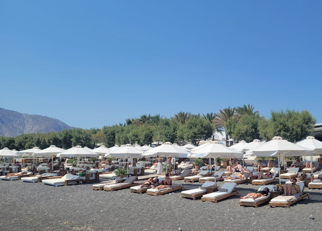 Exterior view of Nikki Beach Resort & Spa in Monolithos, Santorini, featuring the beach.