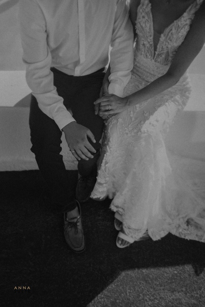 Couple in their wedding attire are sitting in Santorini.