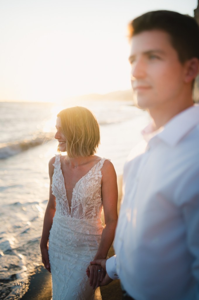 Sunset at the beach. Couple enjoying the view.