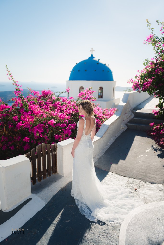 Bride next to the famous blue rooftop of Santorini.