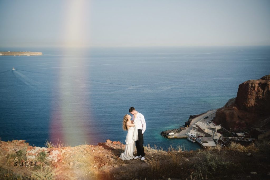 Elegant couple portrait against the backdrop of Santorini's breathtaking caldera views.