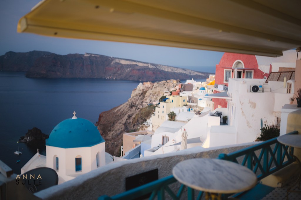 View of Oia blue dome from a restaurant. Greece