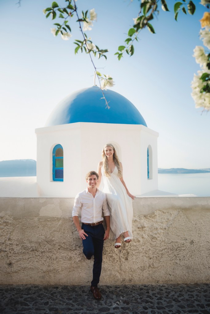 Romantic Santorini photoshoot with blue domes at sunrise