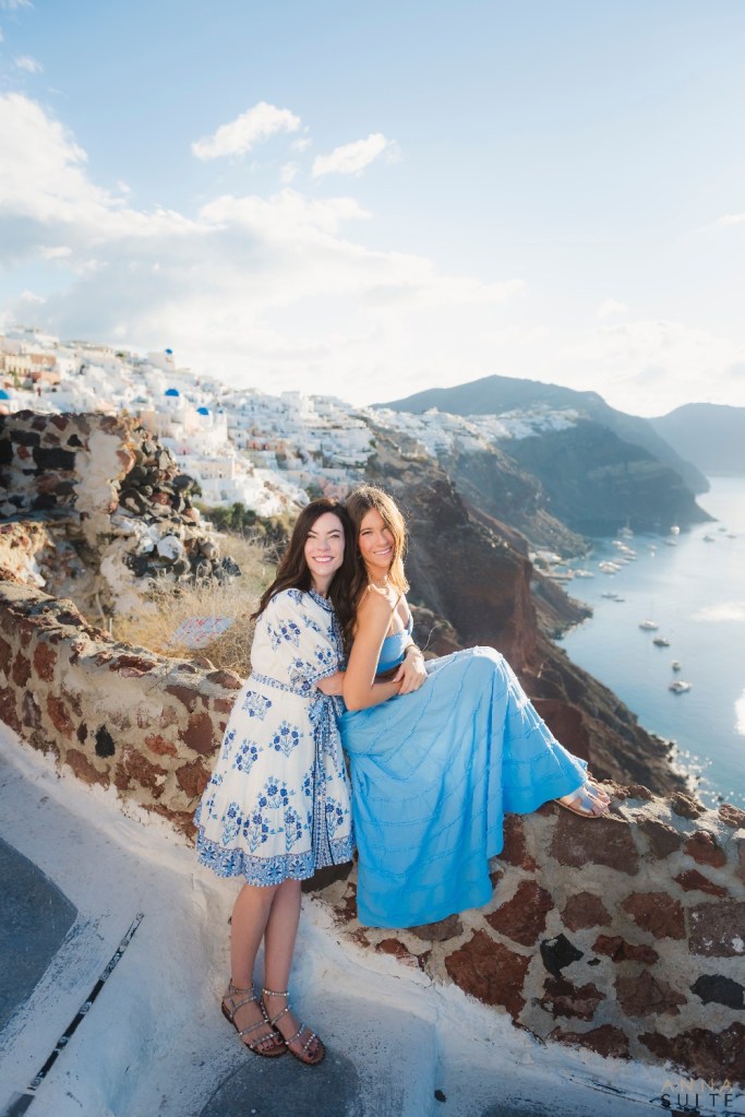 Mum and daughter photo with Santorini blue-domed village in the background