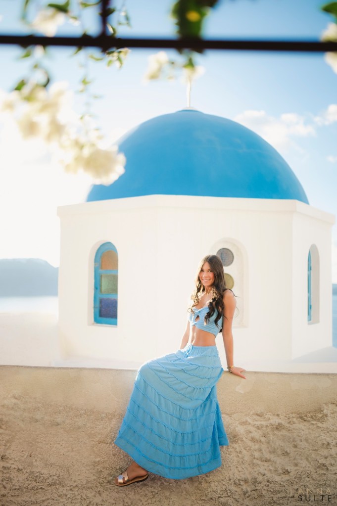 Santorini teen portrait laughing near white and blue village