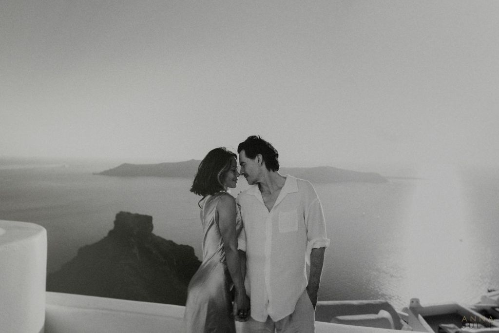 Santorini views. Couple hugging at sunset.