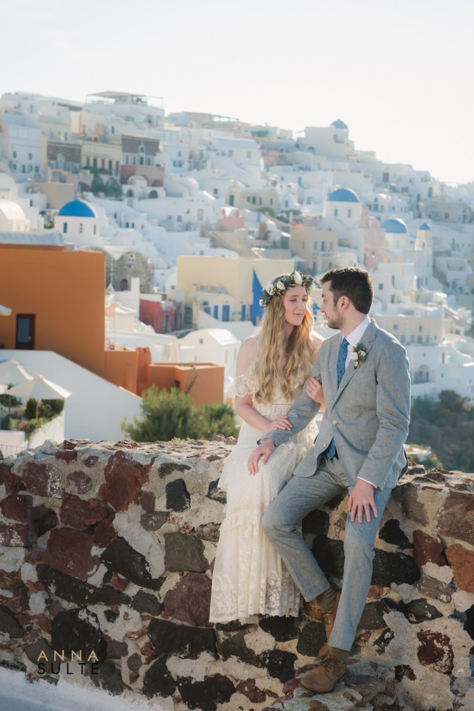 Natural couple photography in Santorini with caldera views and whitewashed houses