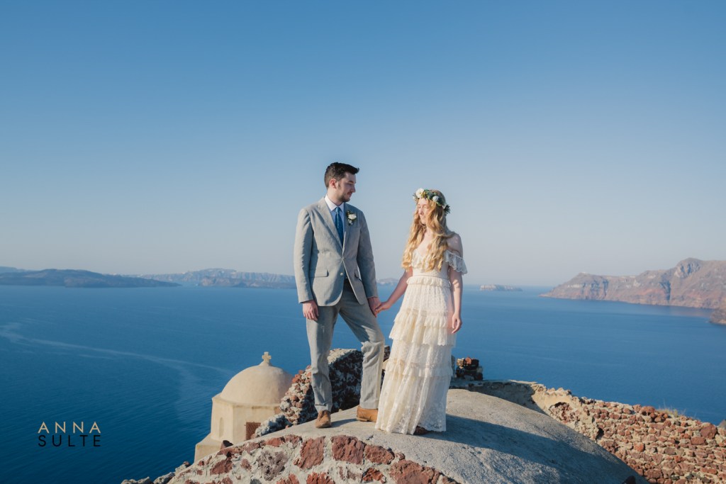 Couple holding hands during a sunset photo session in Santorini