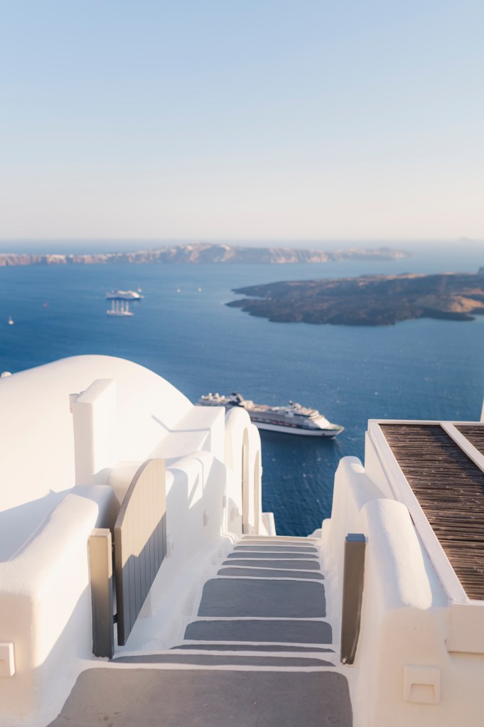 Steps in Santorini. Imerovigli view with the volcano.